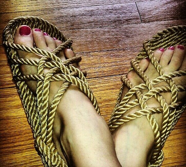 Shelley's feet in Nomadic State of Mine JC sandals in Camel. 