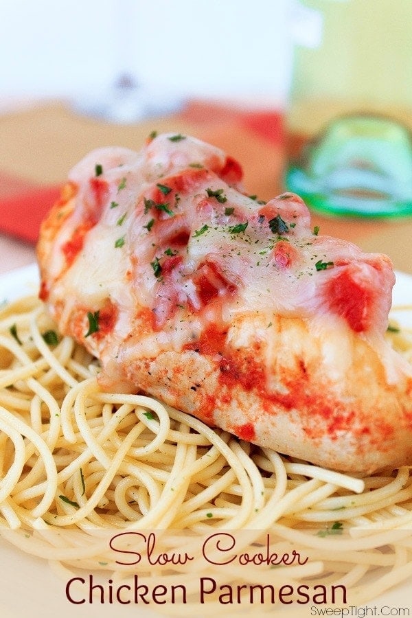 Chicken parmesan on pasta and topped with mozzarella.