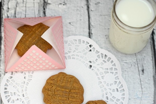 Peanut butter cookies in a pick package next to milk. 