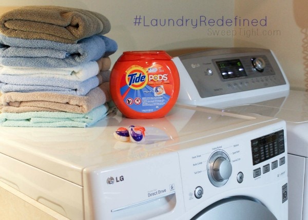 LG washing machines with towels and Tide Pods on top of it. 