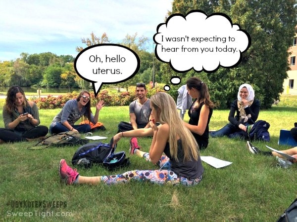 People sitting in a circle outside. 