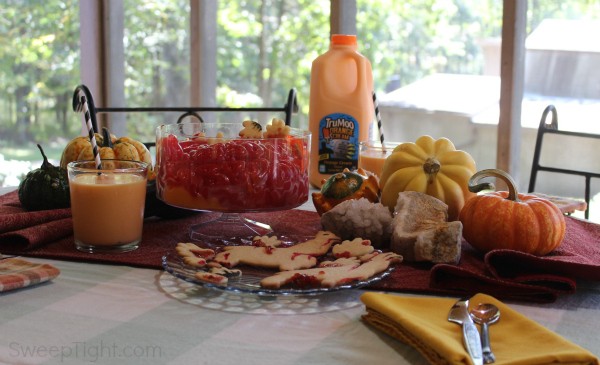 A table full of Halloween decor, cookies, and pudding. 