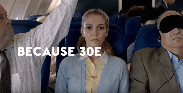 Women on a plane in the middle seat.