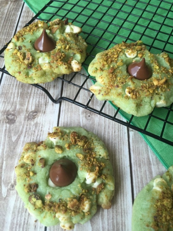 Pistachio kiss cookies on a rack. 