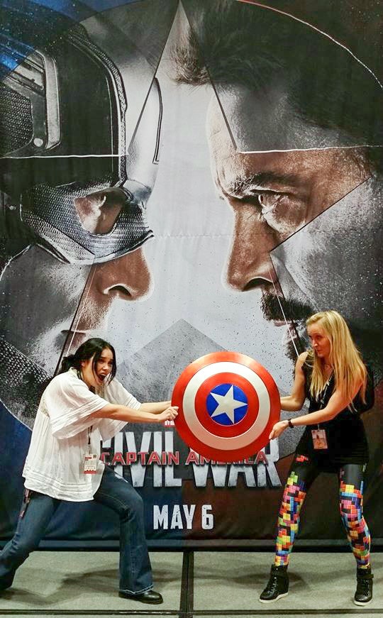 Meredith and Shelley holding a Captain America shield. 