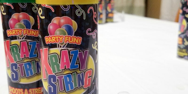 Cans of Krazy String on a table. 