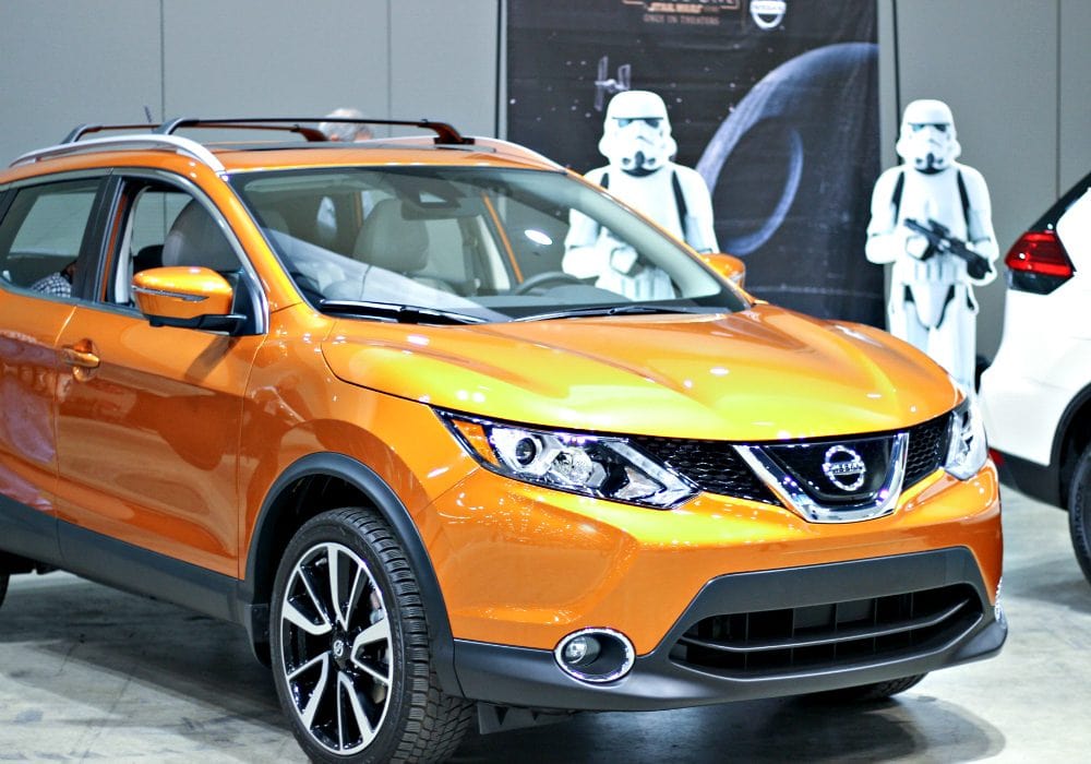 Orange vehicle at the auto show.
