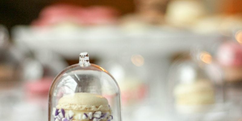 Tiny French Macarons on mini cake stands. 