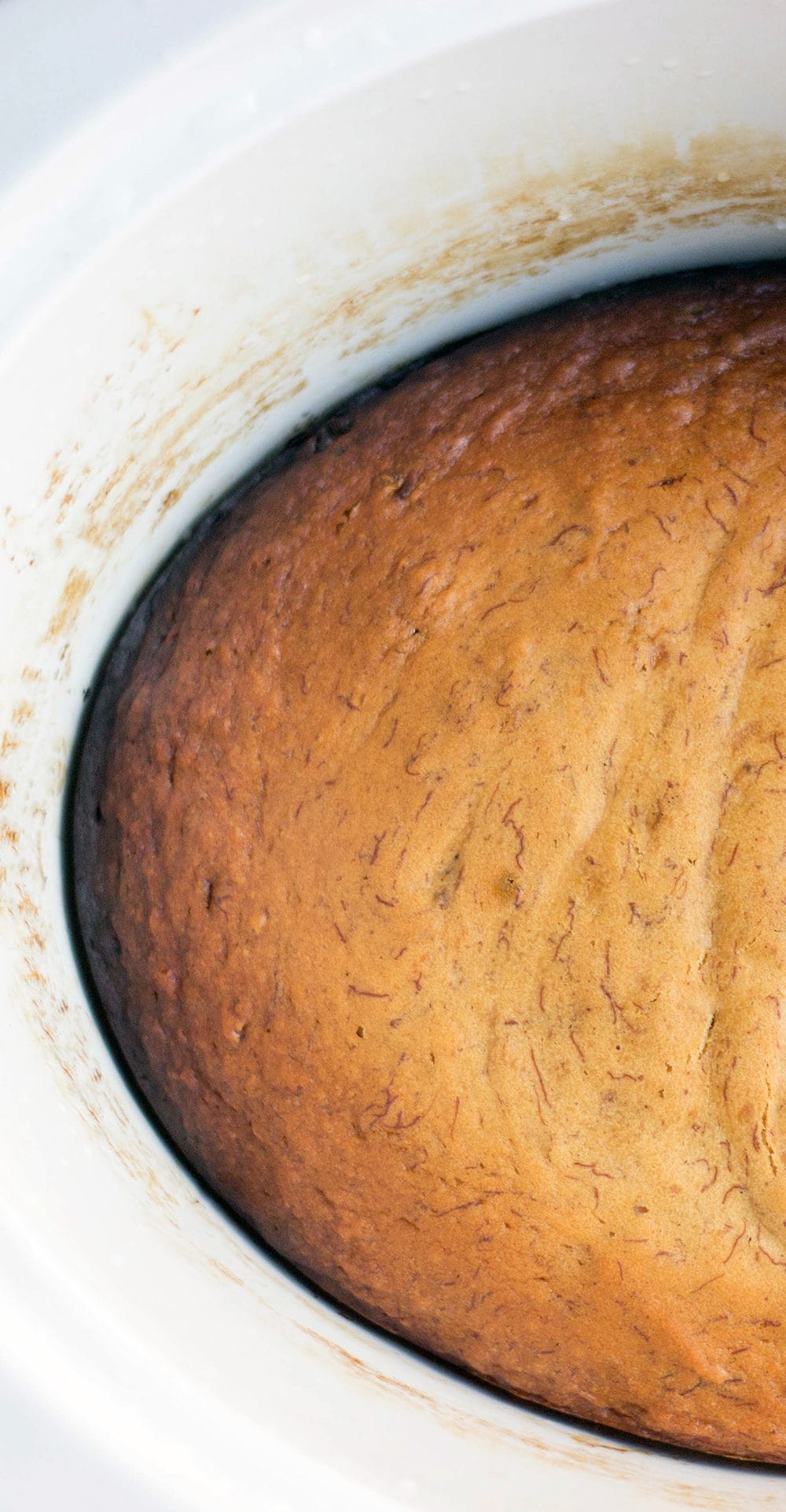 Banana bread in a white crockpot.
