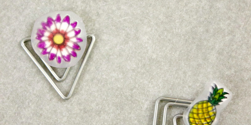 Pumpkin, flower, and pineapple embellishments on paperclips. 