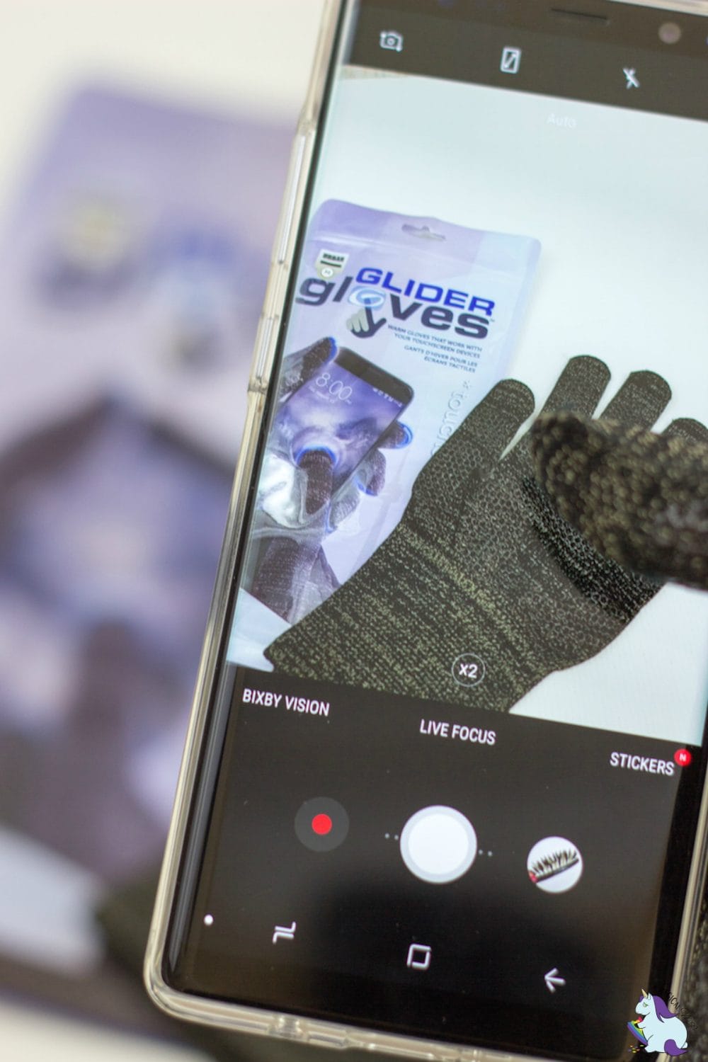 Glider Gloves on a phone while using a finger wearing the gloves.