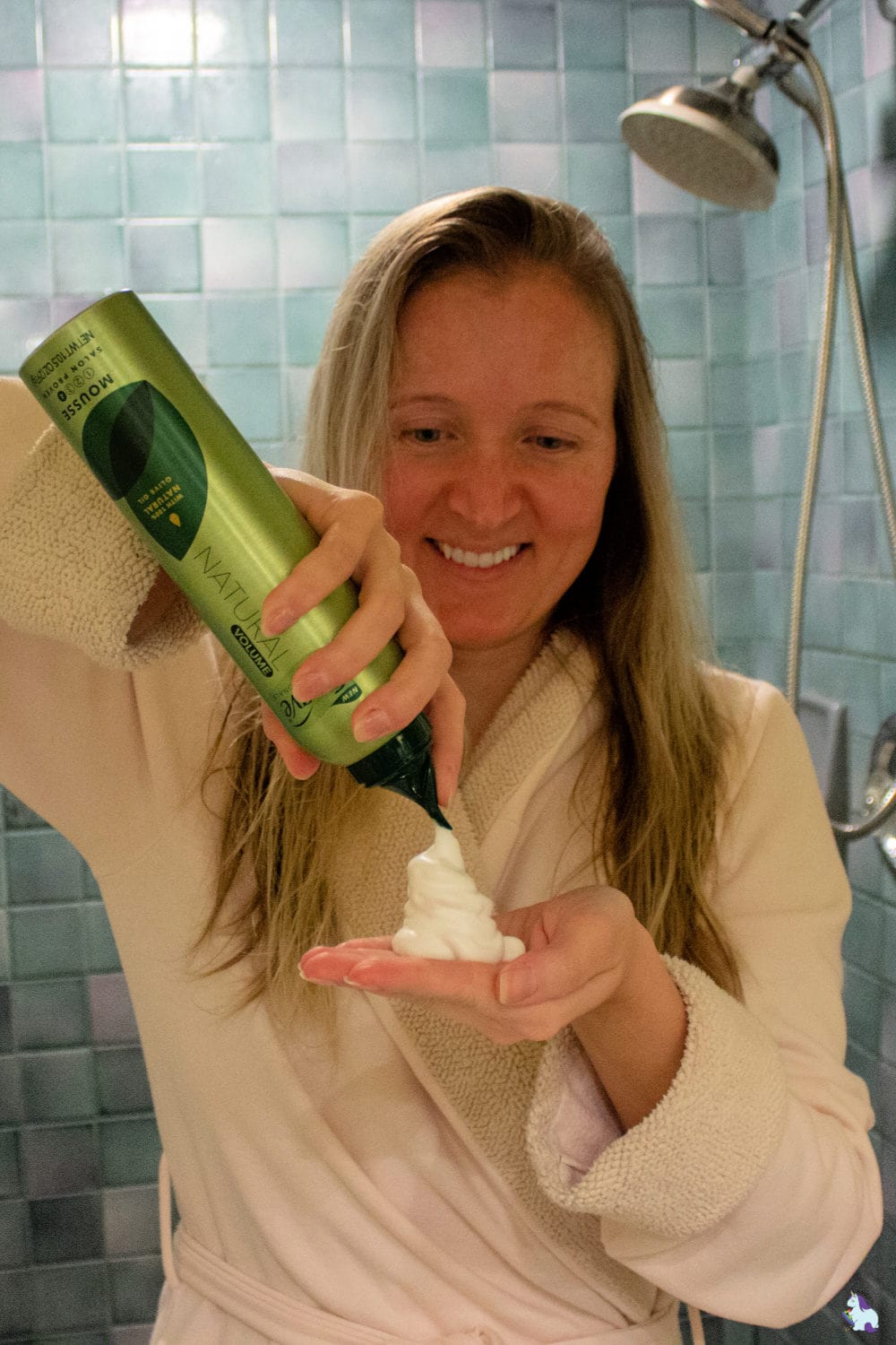 Spraying mousse for hair in my hand.