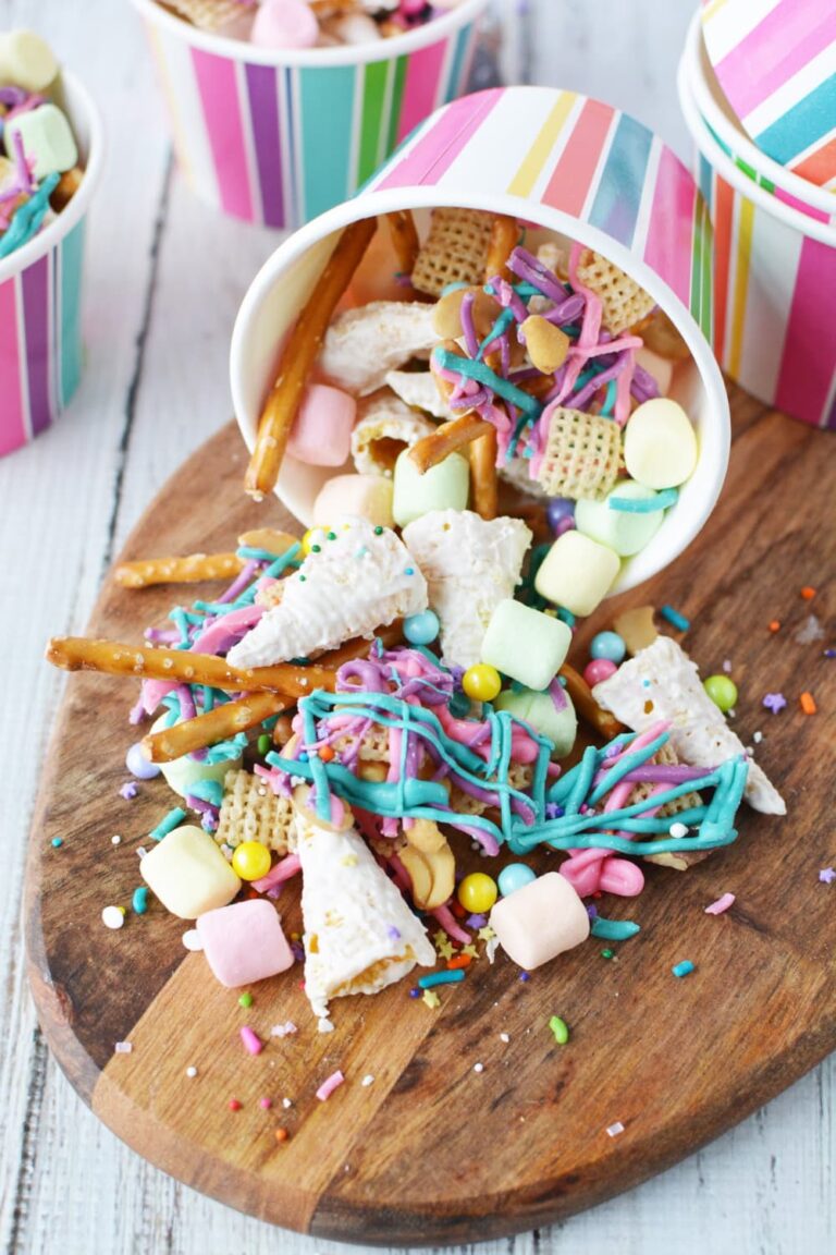 colorful unicorn snack mix spilling out of striped paper cup