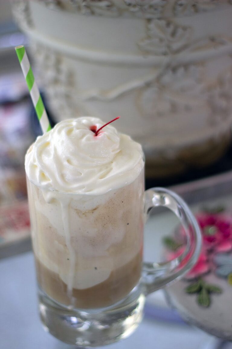 Root beer float sitting on a table.