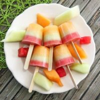 Triple melon frozen pops on a plate.