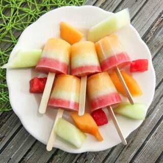 Triple melon frozen pops on a plate.
