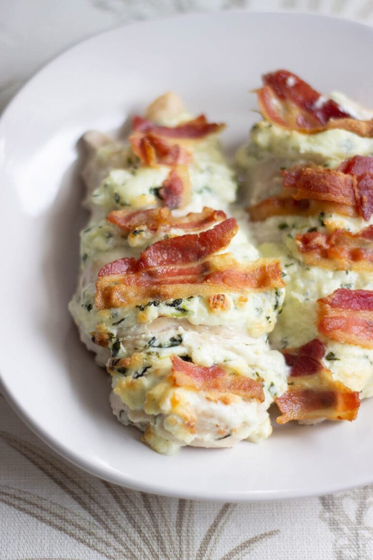 Spinach and bacon Hasselback chicken on a plate.
