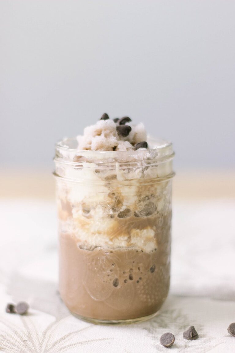 Chocolate shake with whipped cream in a jelly jar.