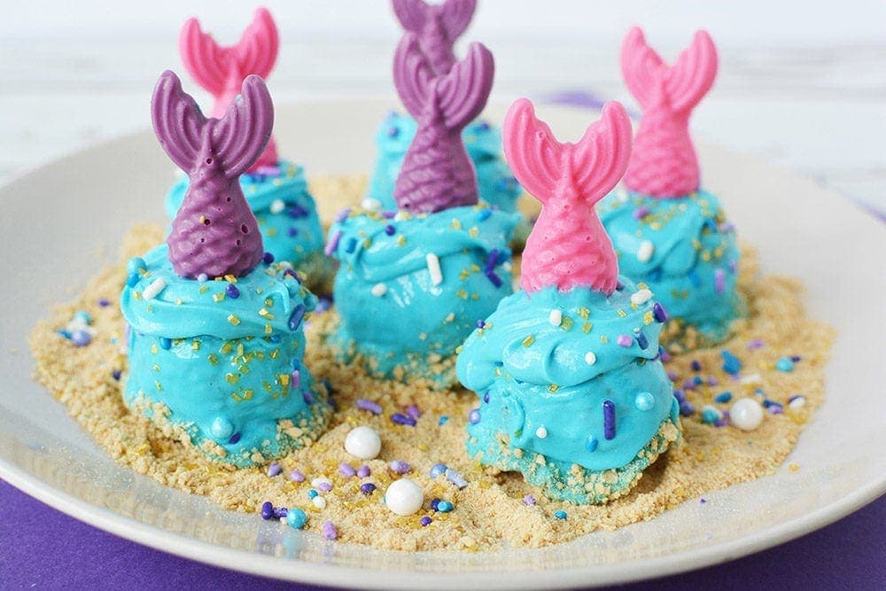 Mermaid donut holes on a plate.