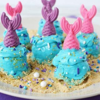 Mermaid donut holes on a plate.