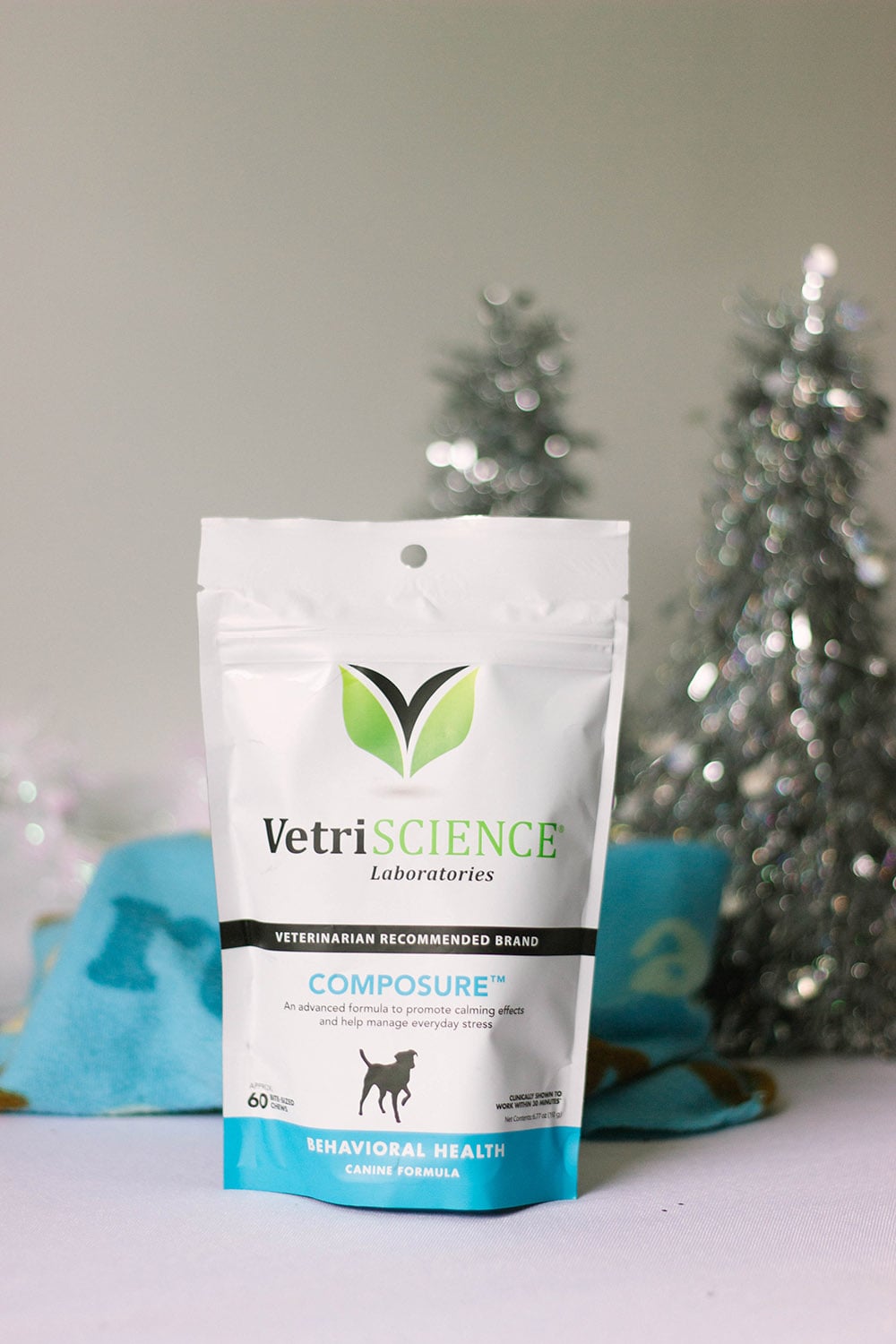 Bag of VetriScience Composure In front of holiday trees and a dog blanket.