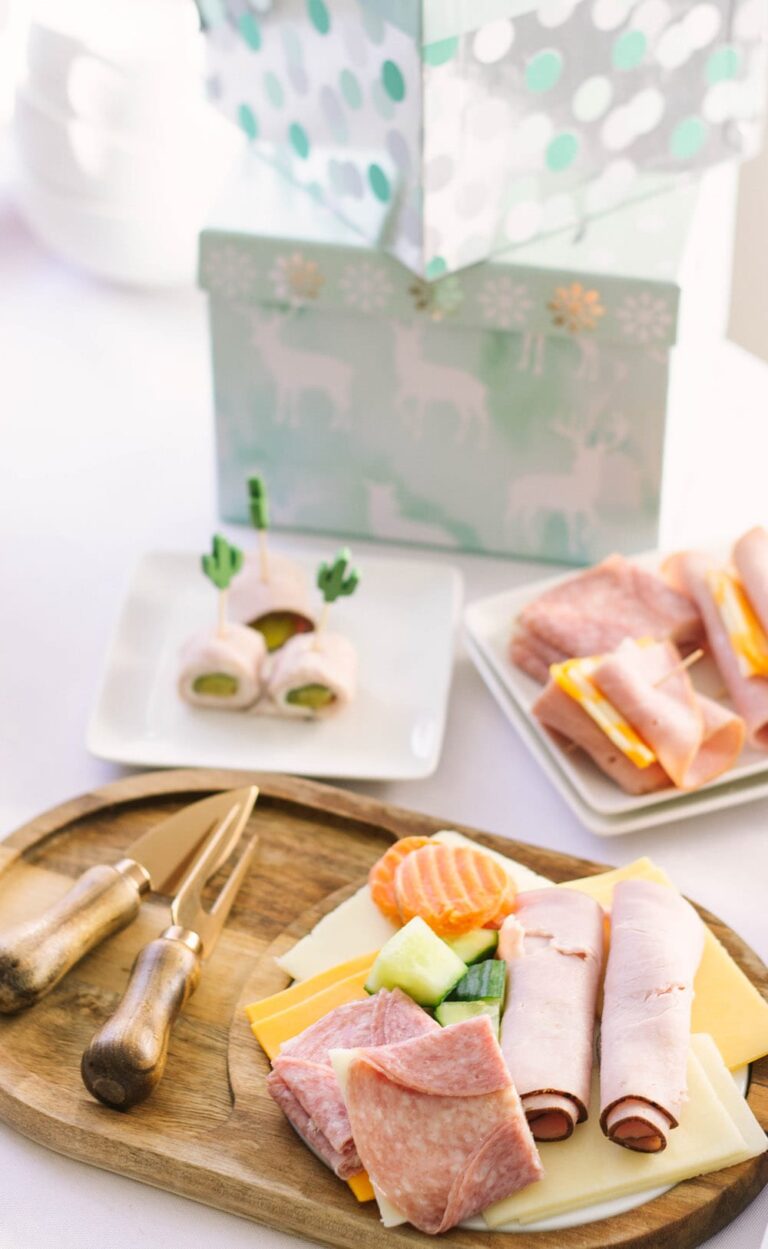 Meats and cheeses on a board and plates
