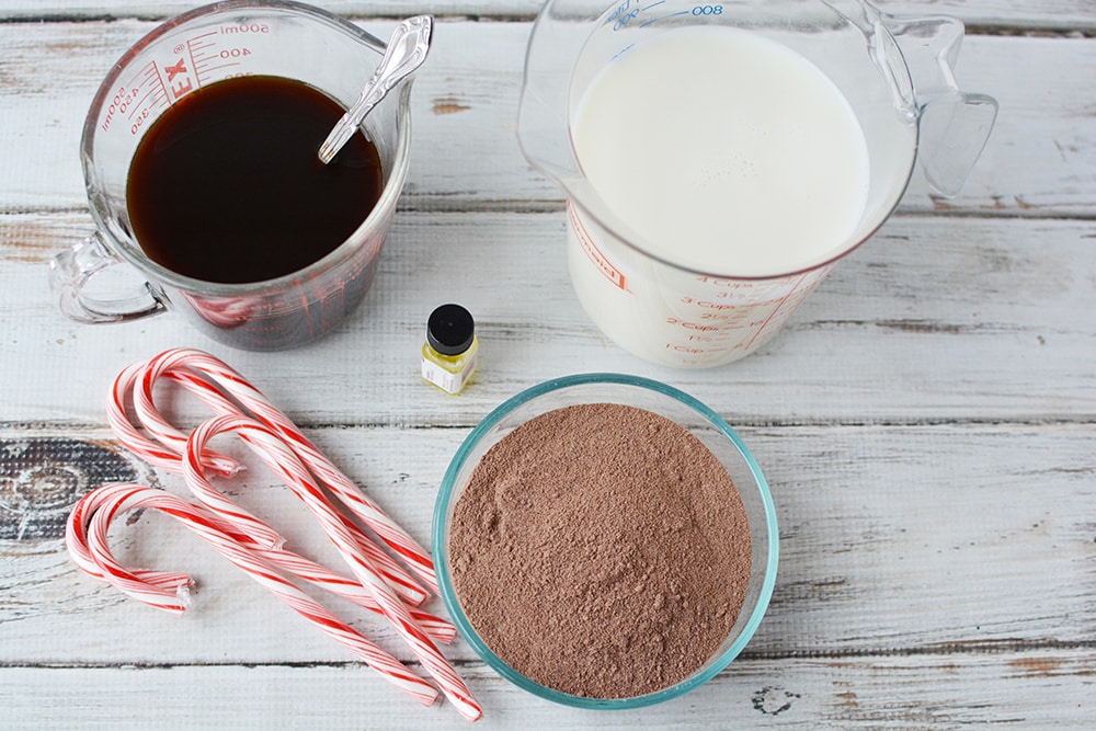 Coffee, candy canes, milk, and hot cocoa mix on a table. 