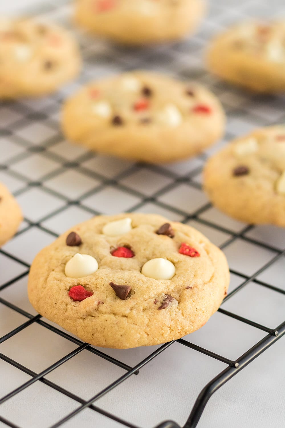 Strawberry cheesecake cookies on rack.