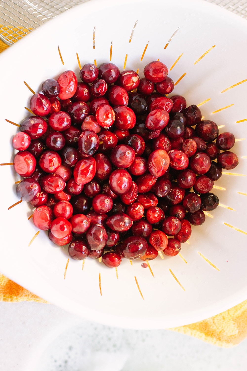 Fresh cranberries in a colander.