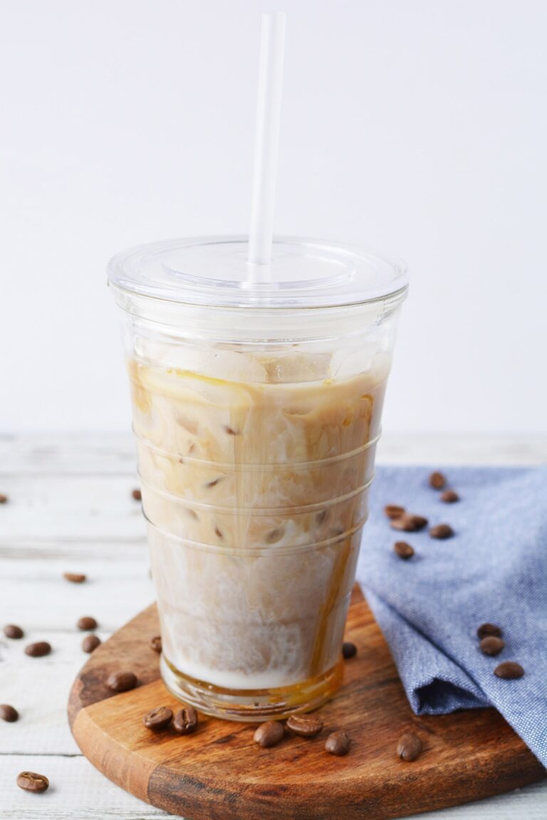 Iced coffee with caramel in a tumbler with straw