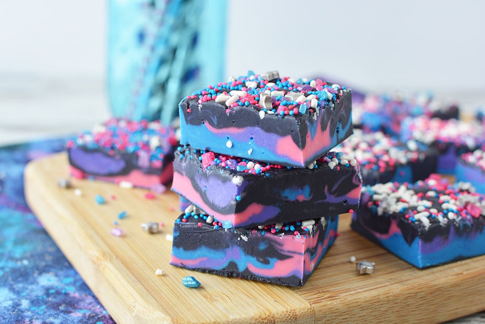 Galaxy chocolate fudge sliced on a cutting boards.