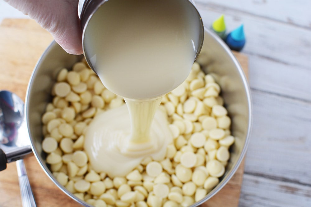Sweetened condensed milk pouring on top of chips.
