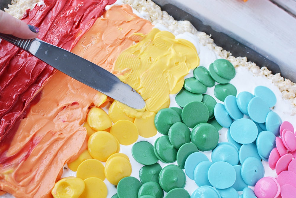 Spreading warm candy melts to make a rainbow. 