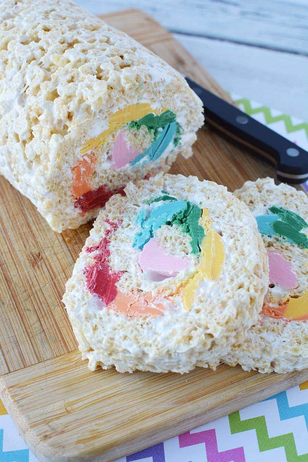 Pinwheel rainbow Rice Krispies treat on a board.