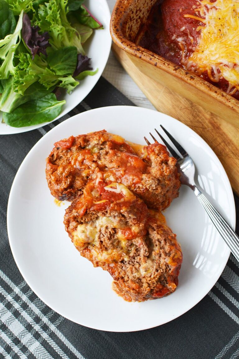 Sliced of cheese sliced meatloaf on a plate with fork