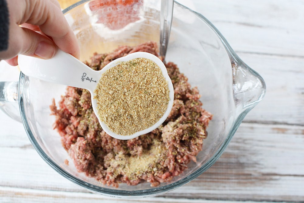 Adding 1/4 cup of bread crumbs into ground beef.