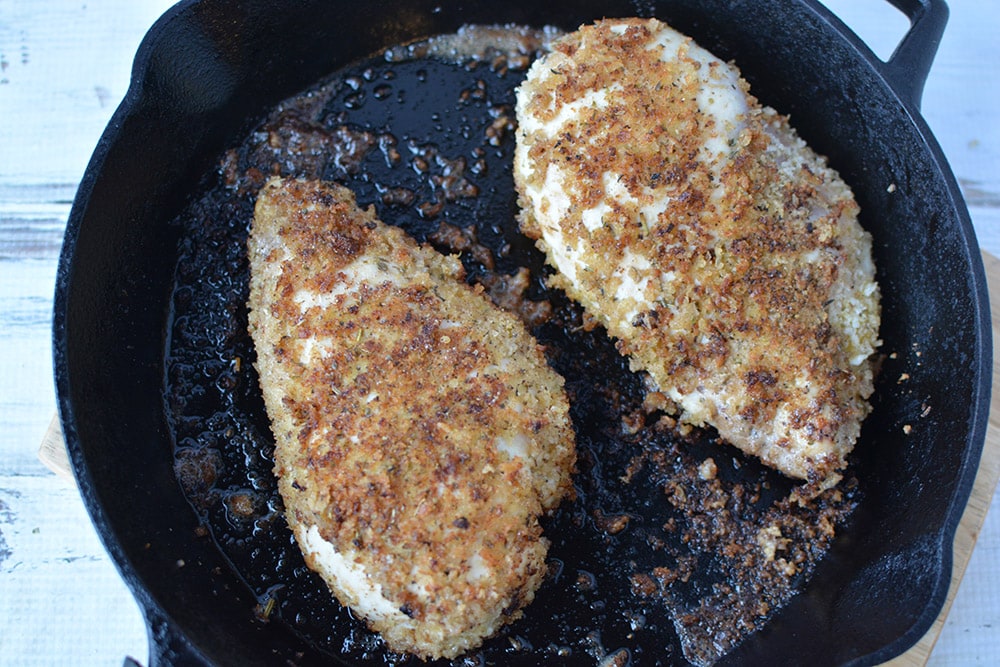 Browned chicken breasts in a skillet.