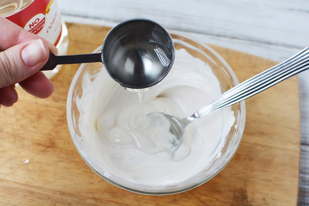 Pouring corn syrup into melted white candy melts.