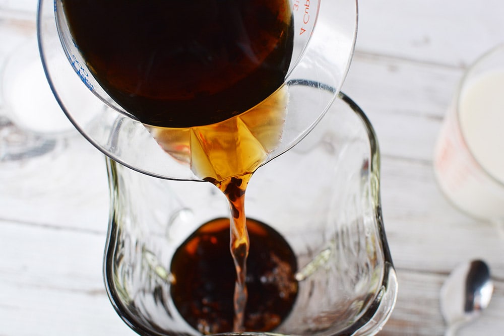 Pouring coffee into a blender. 