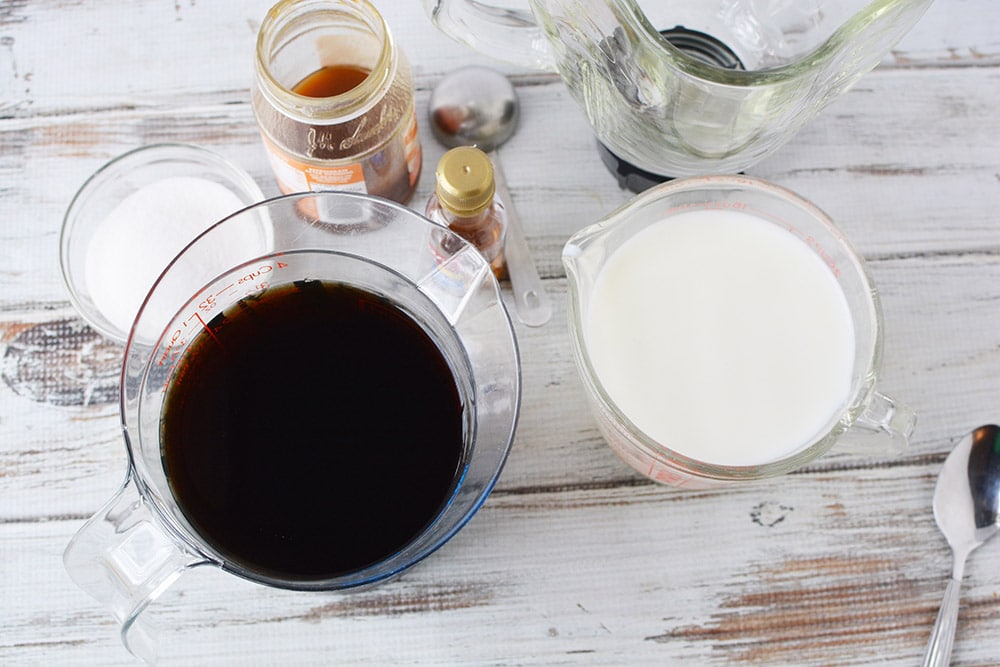 Coffee, milk, caramel sauce, sugar, and a blender. 