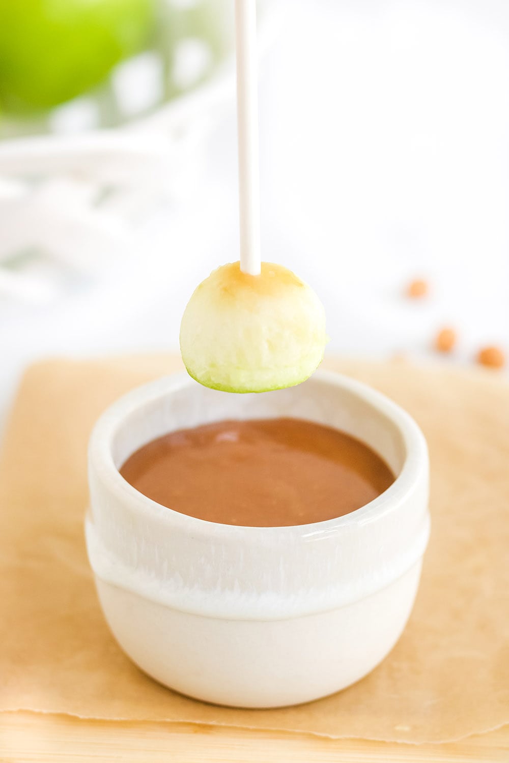 Apple about to dip into caramel.