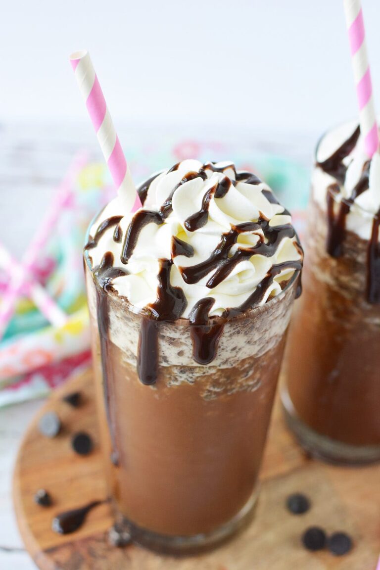 Java chip frappuccino with a pink straw and topped with whipped cream and syrup
