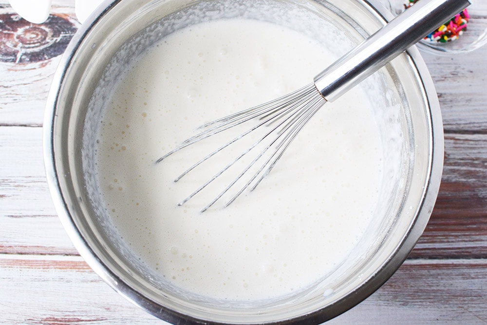 Whisked ice cream ingredients in bowl.
