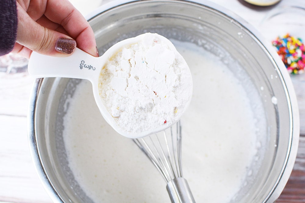 Adding cake mix into bowl.
