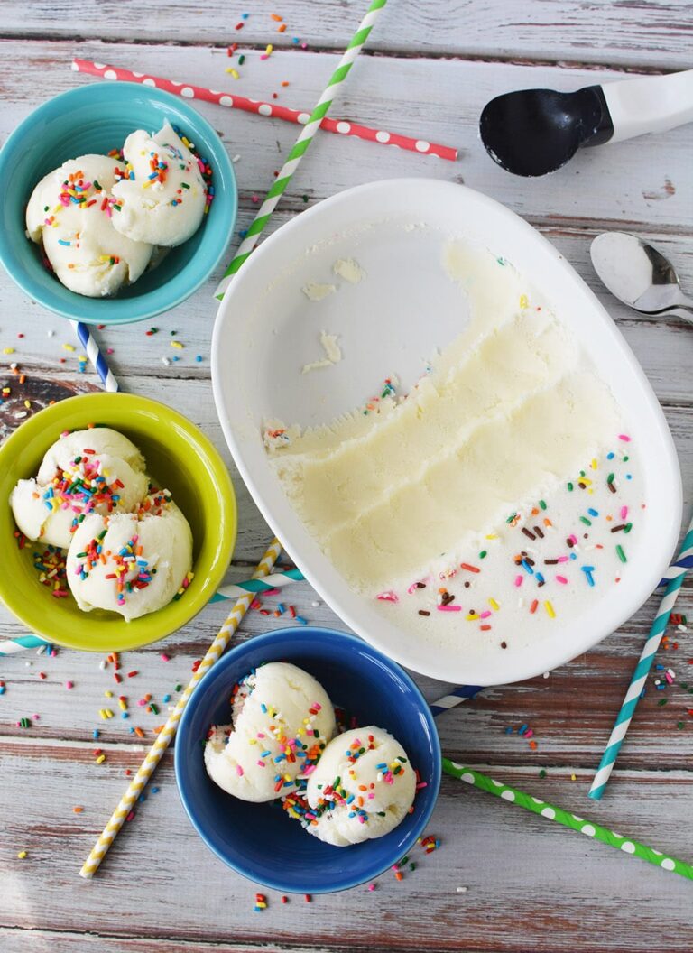 Three bowls of birthday ice cream next to the dish it was frozen in on a table