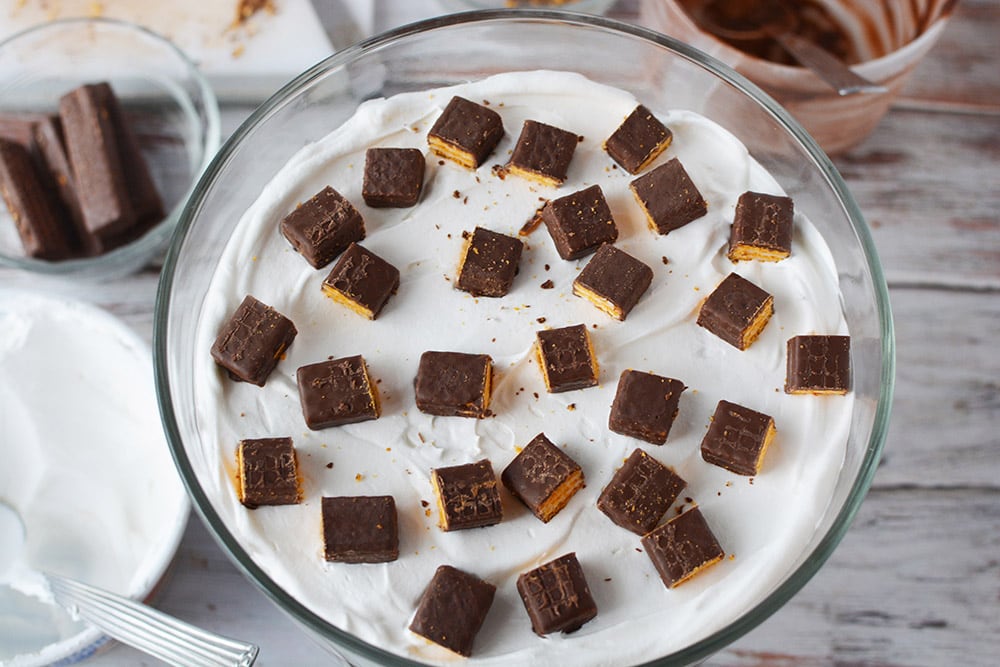 Fudge stick pieces in the trifle bowl on top of whipped cream. 