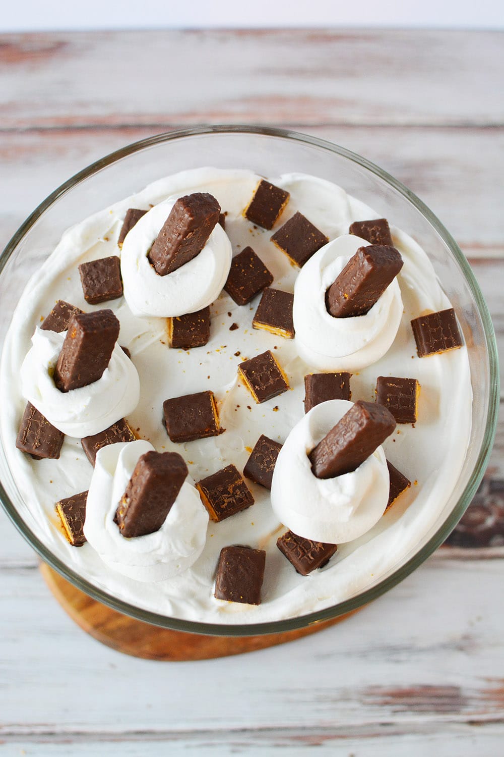 Overhead shot of chocolate trifle with whipped cream and fudge stick cookies on top. 