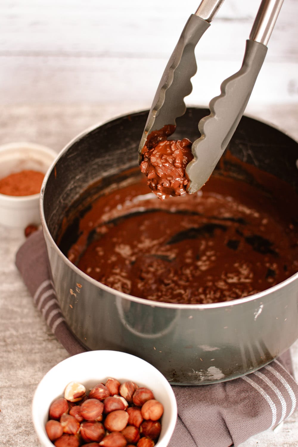 Dipping date bite into chocolate and coconut mixture.