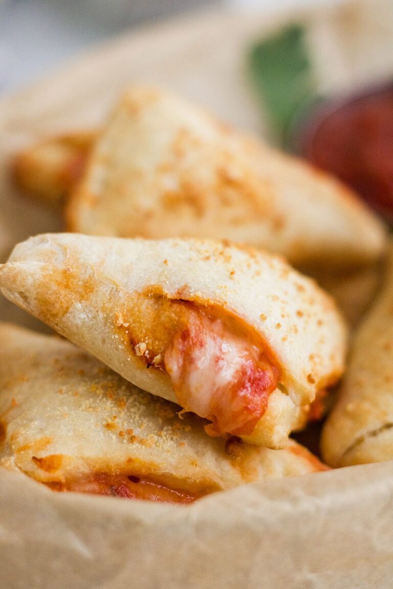 pizza roll with some cheese and sauce oozing out