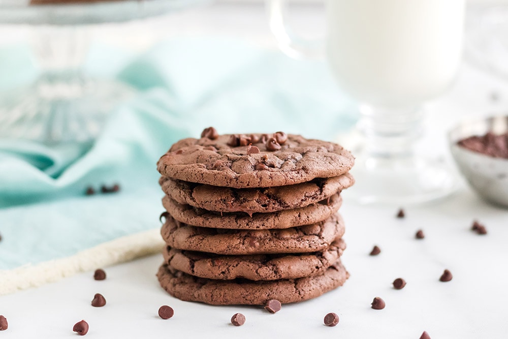 Stack of chocolate chip brownie mix cookies with chips on the table. 
